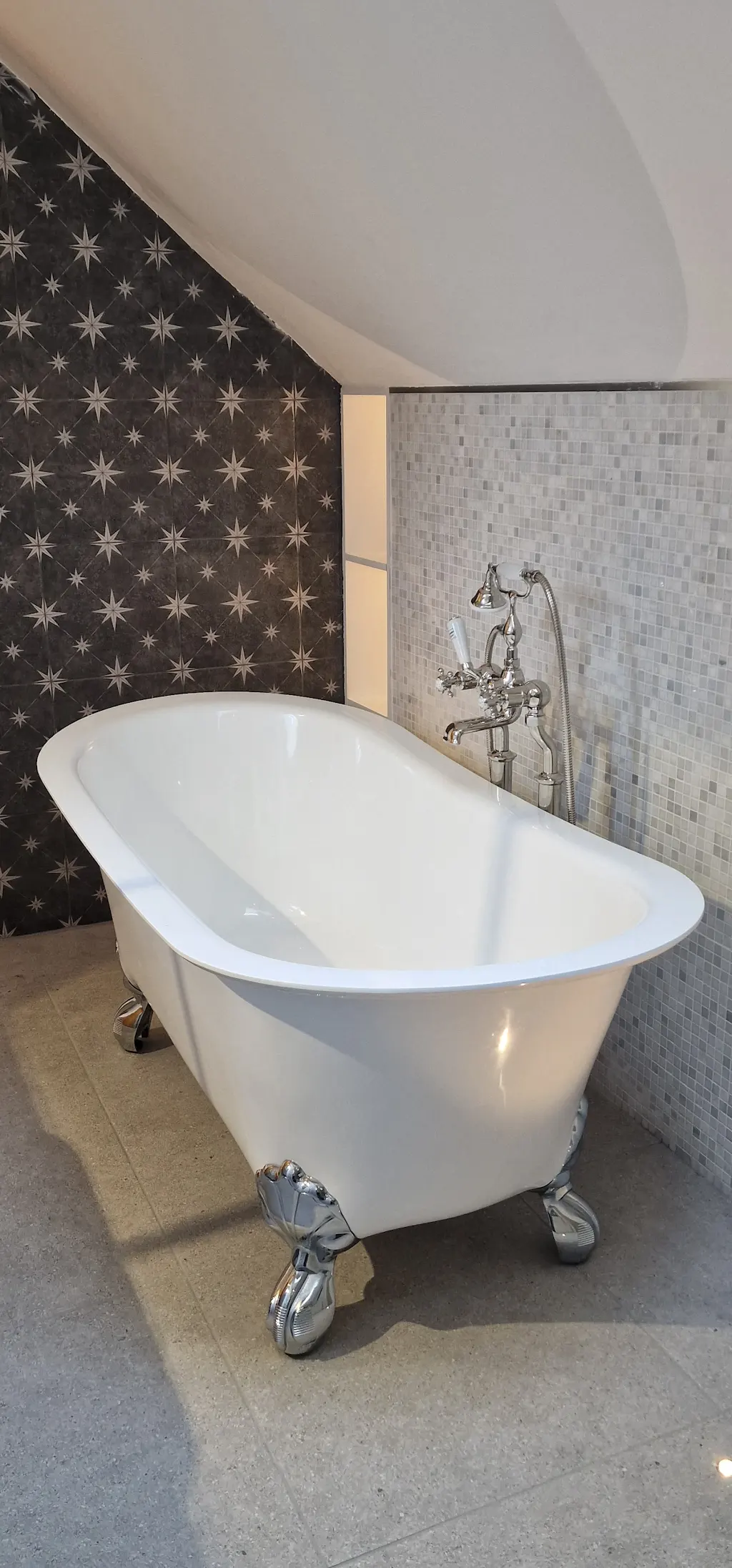 Walk-in shower room with marble hexagon tiles, dark feature wall and brass fittings